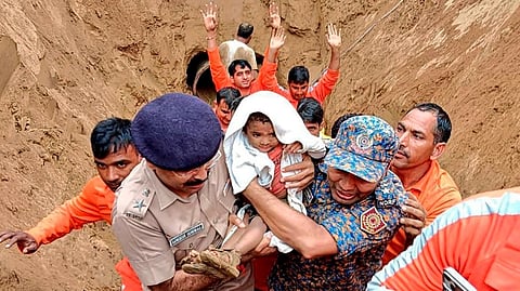 A 2-year-old child, trapped in a 35 feet deep pit, being rescued by NDRF and SDRF personnel, in Dausa, Rajasthan.