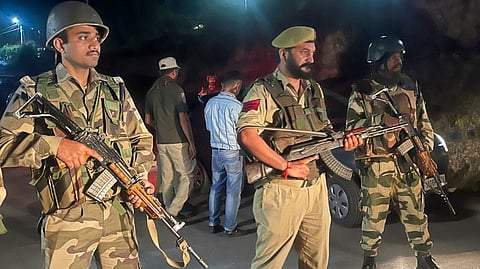 Security personnel stand guard along the Bani-Billawar road after an encounter between security forces and terrorists, in Jammu and Kashmir's Kathua district, Saturday, Sept. 28, 2024. 