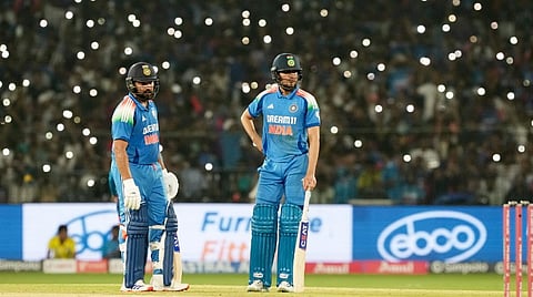 Rohit Sharma and Shubman Gill wait for play to resume amid floodlight failure during the second One Day International (ODI) cricket match of a series between India and England, at Barabati Stadium, in Cuttack, Odisha, Sunday, Feb. 9, 2025. 
