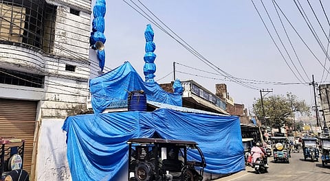 A mosque covered in tarpaulin as prevention against possible holi colour, ahead of traditional 'Laat Saheb' procession on Holi, in Shahjahanpur, Uttar Pradesh, Wednesday, March 12, 2025. 