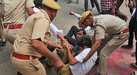 Members of a right-wing group who protest over alleged vandalism at Tejaji temple, in Jaipur being removed by police, Saturday, March 29, 2025.
