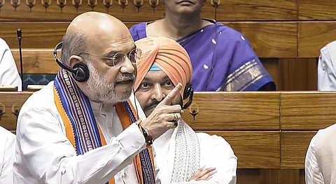 Union Home Minister Amit Shah speaks in the Lok Sabha amid protest by opposition members during the Monsoon session of Parliament, in New Delhi, Wednesday, Aug. 20, 2025. 