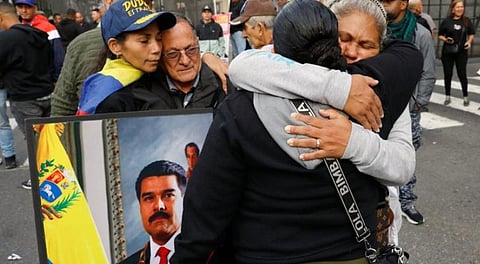 Supporters of Venezuelan President Nicolás Maduro embrace in downtown Caracas after US President Donald Trump announced that Maduro had been captured and flown out of the country.
