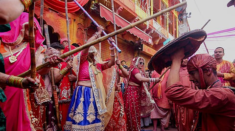 Barsana: People take part in the Lathmar Holi festival celebrations, in Barsana, Mathura, Wednesday, Feb. 25, 2026.