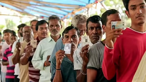 Voters queue at a polling booth during the West Bengal assembly election.