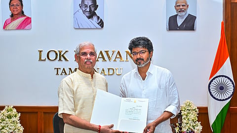 Tamil Nadu Governor Rajendra Vishwanath Arlekar hands over the letter of appointment to TVK chief C Joseph Vijay as the new state Chief Minister, at the Lok Bhavan, in Chennai, Saturday, May 9, 2026.
