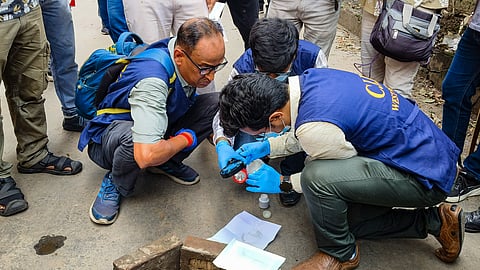 Criminal Investigation Department (CID) officials investigate the crime scene following the killing of BJP leader Suvendu Adhikari's close aide Chandranath Rath, at Madhyamgram, in North 24 Parganas district, West Bengal, Thursday, May 7, 2026.