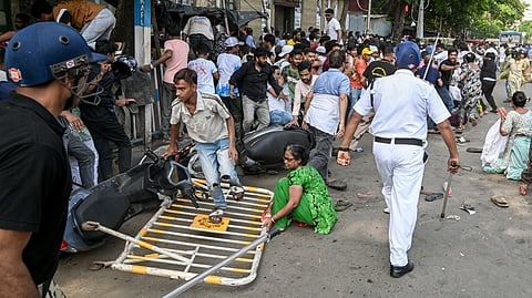 Protestors disperse after being lathicharged by the police during their protest against a recent demolition drive at Tiljala area among other issues, at Park Circus area, in Kolkata, Sunday, May 17, 2026. 