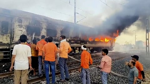 Flames and smoke billow after a fire broke out in an AC coach of the Thiruvananthapuram-Hazrat Nizamuddin Rajdhani Express in Madhya Pradesh's Ratlam district, Sunday, May 17, 2026.