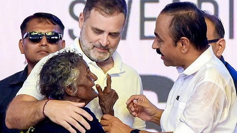 Newly sworn-in Kerala Chief Minister VD Satheesan, right, and LoP in the Lok Sabha Rahul Gandhi interact with an elderly woman after the swearing-in ceremony of the state government, in Thiruvananthapuram, Kerala, Monday, May 18, 2026.