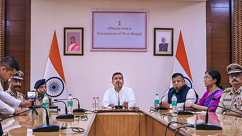 West Bengal Chief Minister Suvendu Adhikari, centre, addresses a press conference, in Howrah on May 18, 2026.