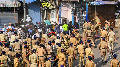 Police personnel resort to lathi-charge during clashes following an anti-encroachment drive in the Gareeb Nagar slum area near Bandra railway station, in Mumbai, Wednesday, May 20, 2026.