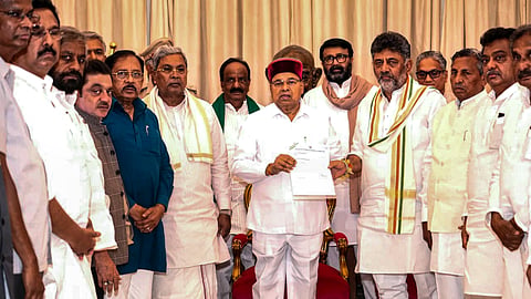 Karnataka Governor Thaawarchand Gehlot receives a letter from Congress President D K Shivakumar on May 30, 2026, as the latter stakes claim to form a new government after he was elected leader of the legislature party, in Bengaluru.