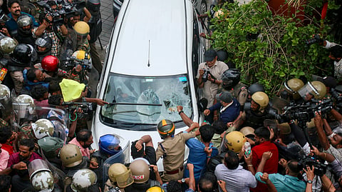 Left Democratic Front (LDF) activists vandalise the vehicle carrying Enforcement Directorate (ED) officials outside former Kerala CM Pinarayi Vijayan's residence after a raid conducted at Vijayan's residence as part of ED's investigation in the CMRL money laundering case, in Thiruvananthapuram, Wednesday, May 27, 2026.