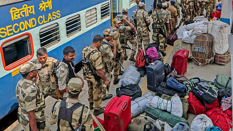 CRPF troops line up to board train