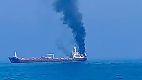Thick smoke billowing from a vessel that came under attack off the coast of Oman,
