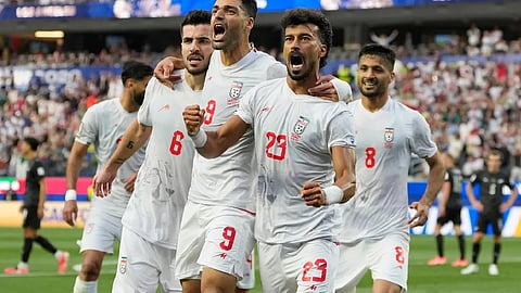 Iran opens its politically charged World Cup by playing to a 2-2 draw with New Zealand 