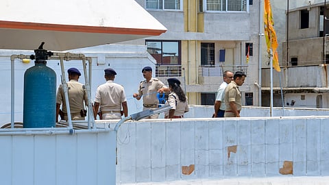 Police personnel inspect the site after RSS alleged that petrol bombs were hurled at its office, in Ranchi, Wednesday, June 17, 2026.