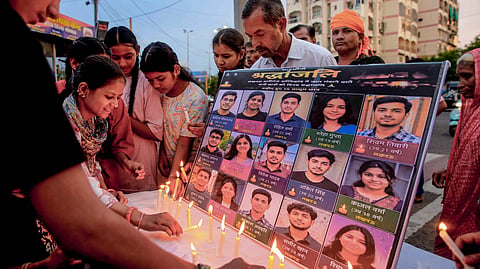 eople light candles to pay tribute to the victims of the Aliganj commercial building fire in Lucknow that claimed 15 lives, in Bhopal, Tuesday, June 23, 2026.