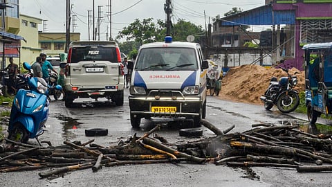 Protesters block a road and stage a protest following the recovery of the body of a 11-year-old girl who went missing a day ago, in Baruipur, South 24 Parganas district, West Bengal, on Sunday, July 5, 2026. 