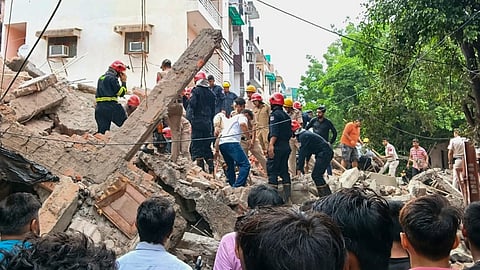 Officials conduct a rescue operation after an under-construction building collapsed at Rohini amid heavy rainfall, in New Delhi, Wednesday, July 8, 2026. 