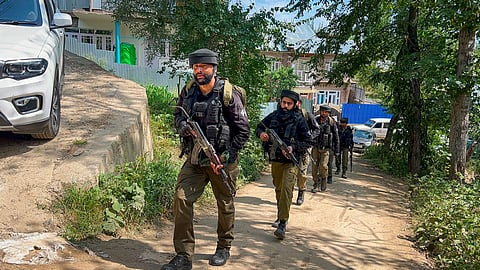 Security personnel keep vigil near the encounter site at Chanapora as the anti-terror operation enters its fifth day, in Shopian district, Jammu and Kashmir, Wednesday, July 8, 2026.