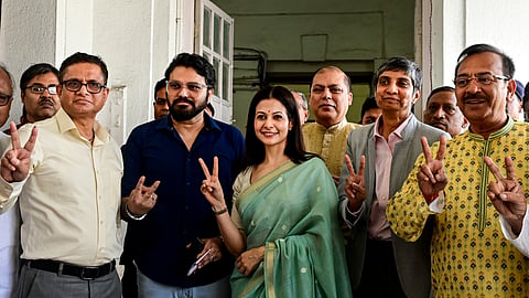 From row from left, former West Bengal DGP Rajeev Kumar, singer and West Bengal Minister Babul Supriyo, actor Koel Mallick and senior Supreme Court advocate Menaka Guruswamy show victory sign after filing their nominations as TMC candidates for the upcoming Rajya Sabha elections, at the state Legislative Assembly, in Kolkata, Thursday, March 5, 2026.