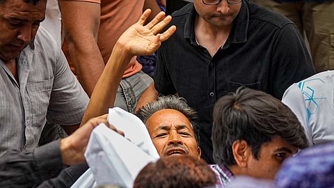 Activist Sonam Wangchuk, who has been on an indefinite hunger strike for 21 days, waves as he is shifted to a hospital from Jantar Mantar, in New Delhi, Saturday, July 18, 2026.