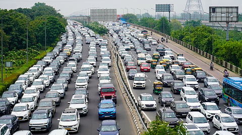 Vehicles caught in a traffic jam on the Ring Road as a protest march towards Parliament causes congestion, in New Delhi, Monday, July 20, 2026.
