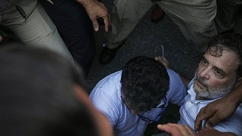 Security personnel detain Leader of Opposition in the Lok Sabha Rahul Gandhi during a sit-in protest near the Prime Minister's residence over alleged irregularities in the NEET examination, in New Delhi, Tuesday, July 21, 2026.