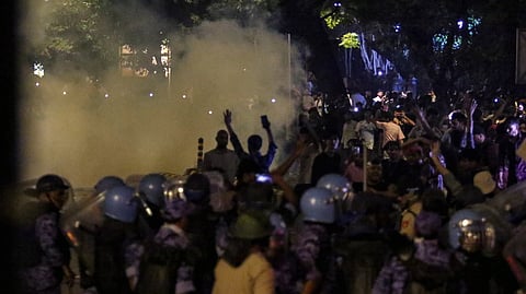 Security officials use tear gas during the ongoing protest over alleged irregularities in the NEET examination, near Jantar Mantar in New Delhi, Wednesday, July 22, 2026.