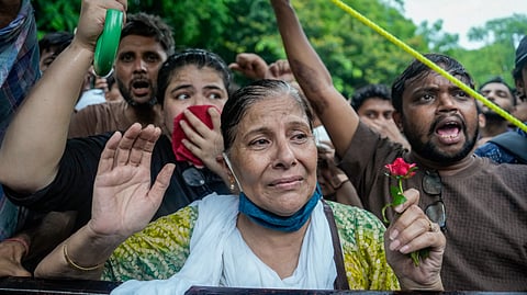 An emotional protester reacts as students and supporters gather during an ongoing demonstration over the NEET issue, a day after clashes with police, at Jantar Mantar, in New Delhi, Tuesday, July 21, 2026.