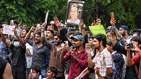 People gather at Sansad Marg to join the Cockroach Janta Party (CJP) protest demanding the resignation of Union Education Minister Dharmendra Pradhan over NEET paper leak issue, in New Delhi, Thursday, July 23, 2026.