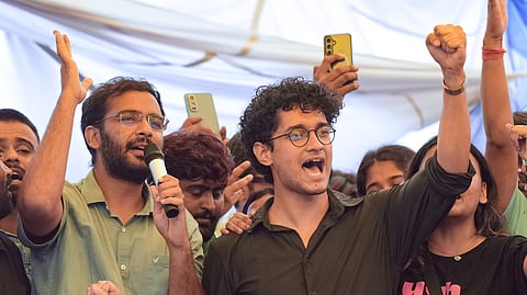 Cockroach Janta Party (CJP) Spokespersons Saurav Das and Ashutosh Ranka, with supporters, celebrate after Union Education Minister Dharmendra Pradhan resigned and took responsibility for the NEET paper leak, at Jantar Mantar in New Delhi, Saturday, July 25, 2026.
