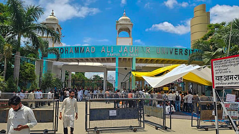 People gather outside the Mohammad Ali Jauhar University during a sit-in protest over the order for demolition of 38 buildings of the university, in Rampur, Uttar Pradesh, Thursday, July 23, 2026.