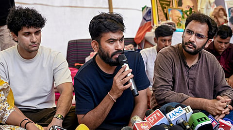 Cockroach Janta Party (CJP) founder Abhijeet Dipke addresses a press conference as party spokepersons Saurav Das and Ashutosh Ranka look on, amid the ongoing protest over NEET paper leak issue, at Jantar Mantar, in New Delhi, Friday, July 24, 2026.