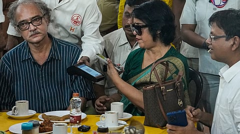 Exiled Bangladeshi author Taslima Nasrin attempts to make a digital payment during her visit to the historic College Street Coffee House, in Kolkata, West Bengal, Monday, Aug. 3, 2026. 