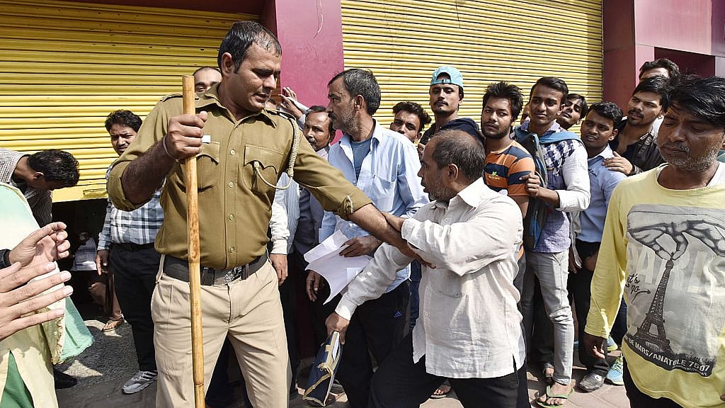 Policing a queue outside a bank, after the government demonetised Rs 500 and 1,000 currency notes, in New Delhi, on November 16, 2016