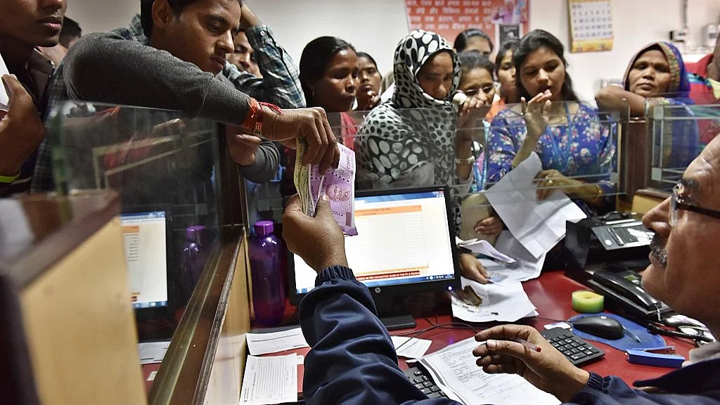 A banker exchanges defunct currency notes at a PNB branch,  New Delhi