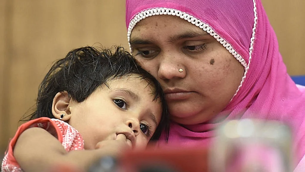 Bilkis Bano, 15 years after the event, holds her infant daughter. The Bombay High Court had just upheld the rapists' life sentence & convicted 5 policemen, 2 doctors for covering up the crime (photo: Raj K Raj/Hindustan Times/Getty Images)