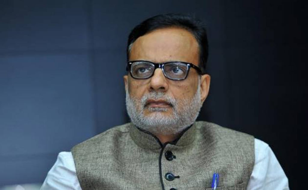 Who gave gold biscuits to Hasmukh Adhia?
