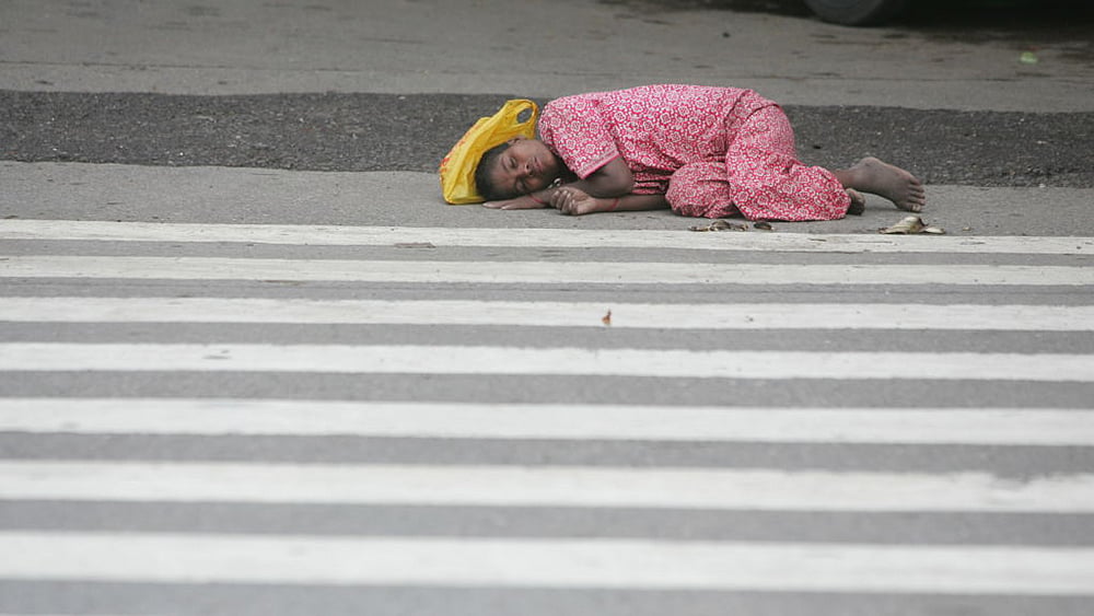 File photo of a  homeless woman sleeping on the streets of Mumbai; Photo by Manoj Patil/Hindustan Times via Getty Images
