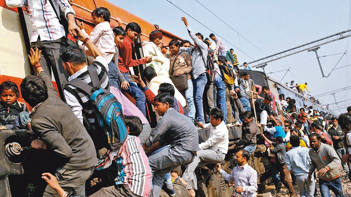 Passengers vie for space on the engine and coaches of an overcrowded train 