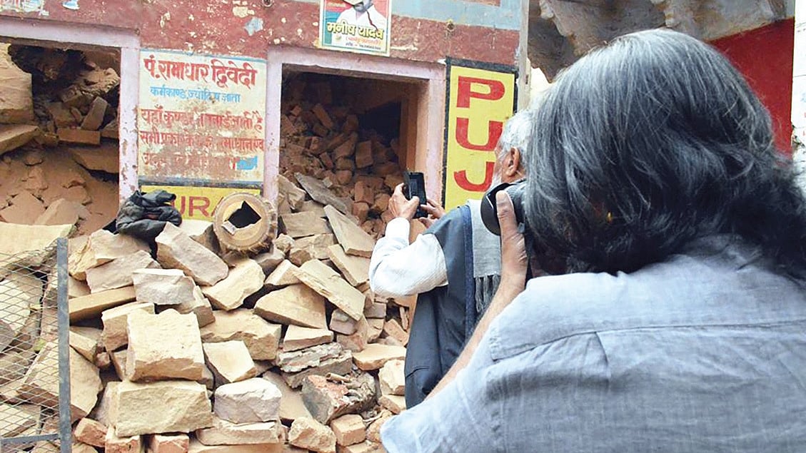 Photographers picturing a demolished building