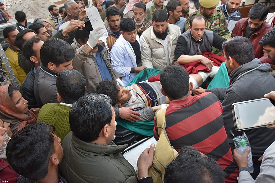 People shift a civilian for treatments after he received injuries during firing and mortar shelling by the Pakistani Army along the LoC in Poonch district of Jammu and Kashmir on February 28, 2019.