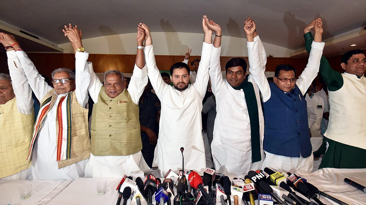 Rashtriya Janata Dal leader Tejashwi Yadav, Hindustani Awam Morcha (Secular) Chief Jitan Ram Manjhi and other leaders join hands after announcing the grand alliances candidates list for the upcoming Lok Sabha elections 2019, in Patna (PTI)