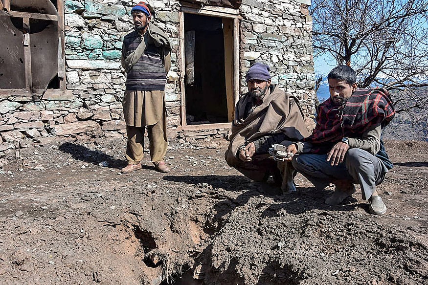 Villagers show a damage portion in front of a house after shelling by the Pakistani Army in Chhajla Patri village near the Line of Control (LoC), in the Mankote sector of Poonch.