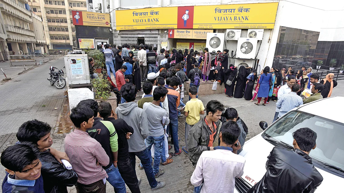 People stand in a queue outside banks to deposit and exchange old denomination, at Barakhamba Road