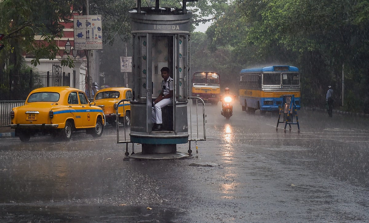 A traffic police personnel sits inside a kiosk during rainfall, in Kolkata, Friday, May 3 (PTI)