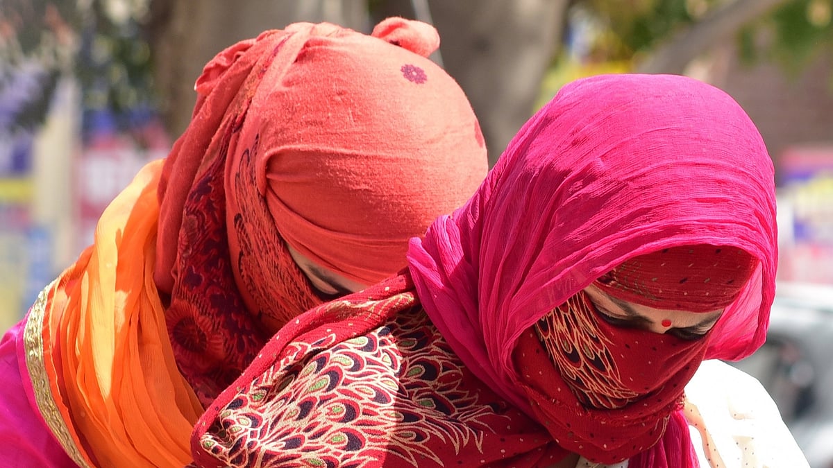 Women cover their faces to avoid scorching sun on a hot day. (File Photo: IANS) 